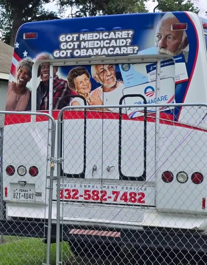 The Integrity Insurance mobile enrollment vehicle, with the agency phone number on the back