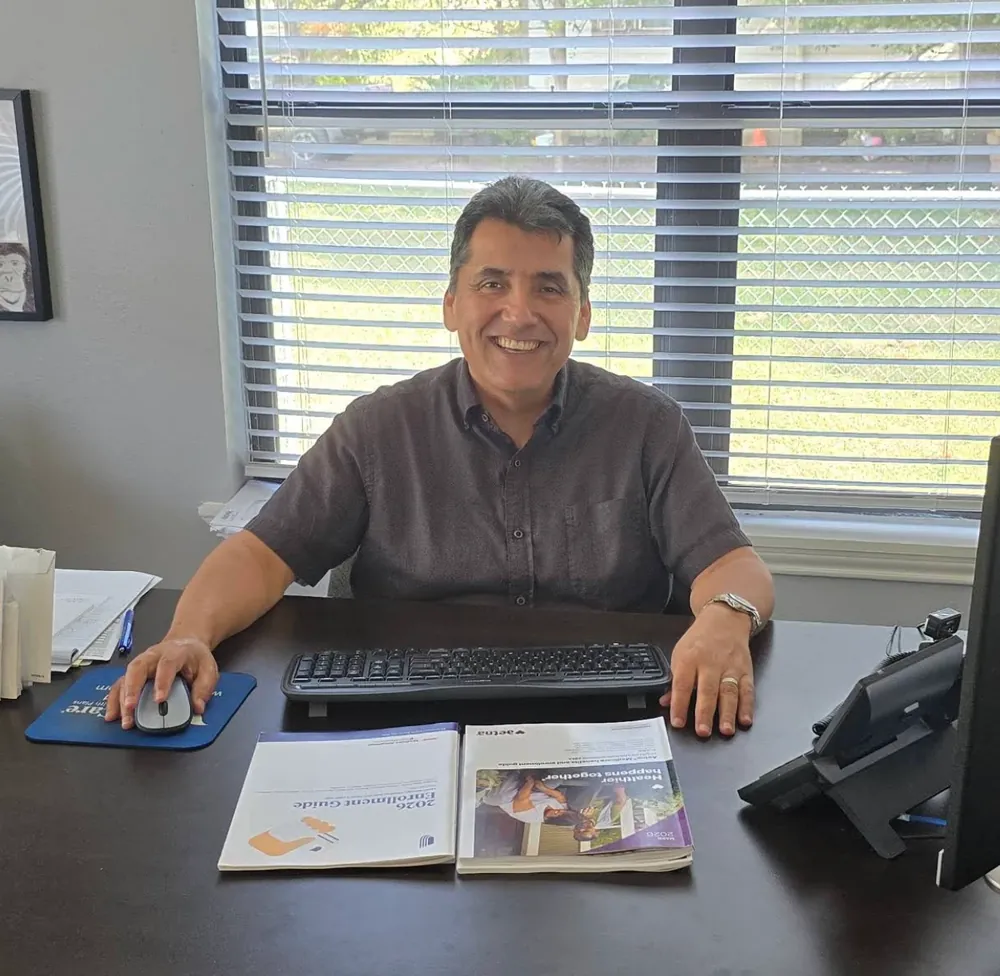 Nelson Gonzalez at his desk in the Integrity Insurance office