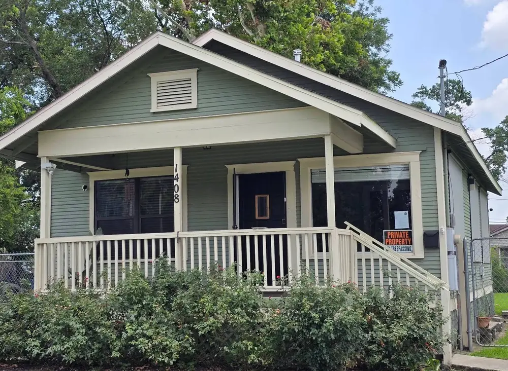 The green house at 1408 E 31st St, home of Integrity Insurance Service