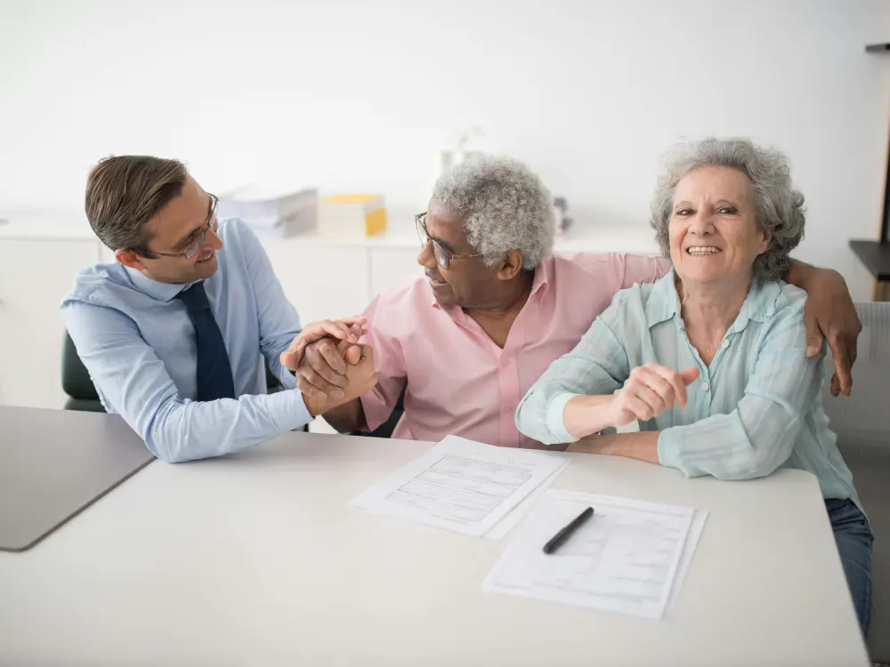 An insurance agent going through Medicare paperwork with a couple