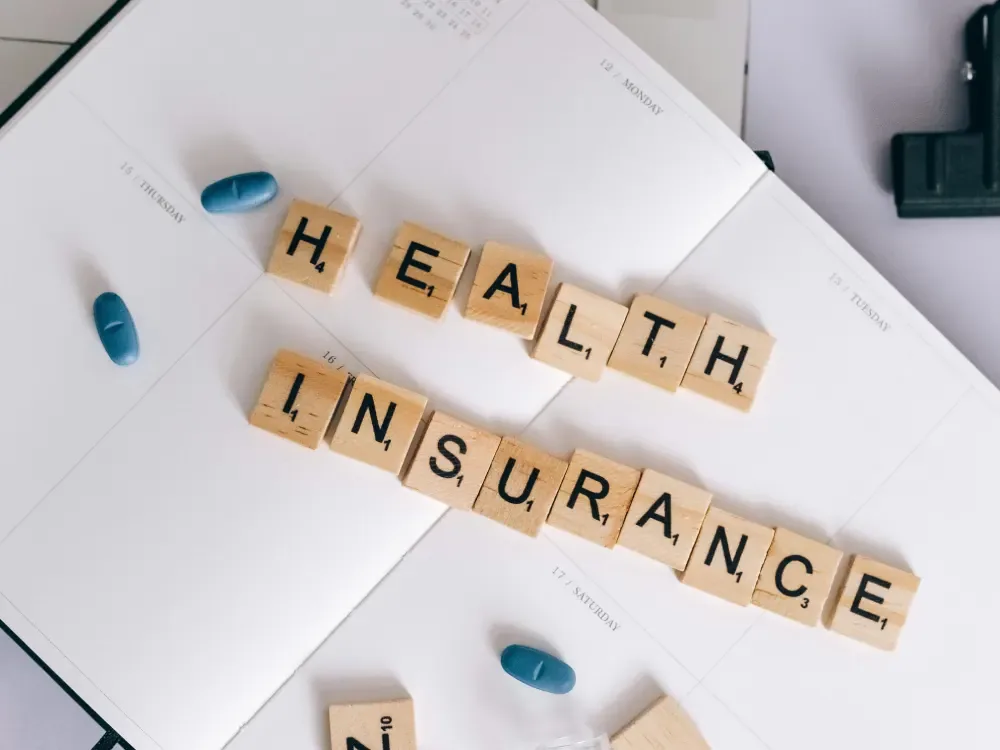 A family reviewing health insurance paperwork together at a kitchen table